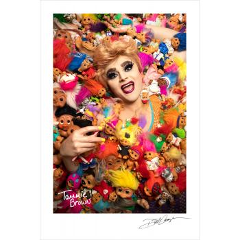 Tammie Brown photographed in a bed of Troll dolls by Dusti Cunningham